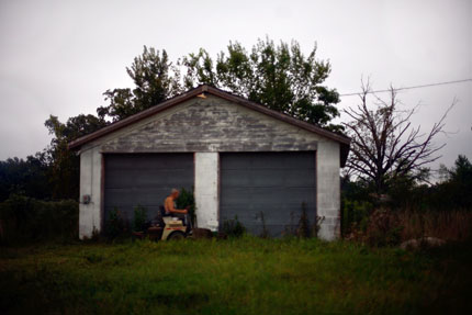 man on lawnmower.